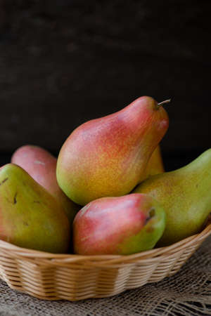 fresh pears in the plate, on the wooden backgroundの写真素材