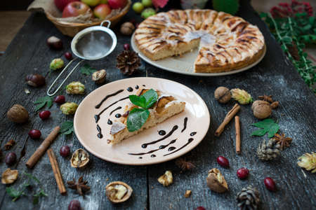 Slice of homemade apple pie on wooden tableの写真素材
