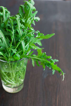 fresh ruccola leaves on wooden backgroundの写真素材