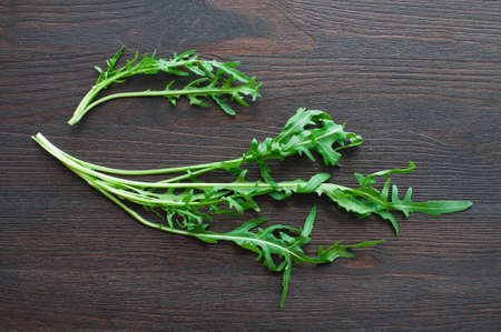 fresh ruccola leaves on wooden backgroundの写真素材