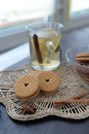 Cream cookies with vanilla and chocolate on the wooden tableの写真素材