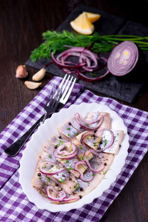 Herring salad with onion and herbsの写真素材