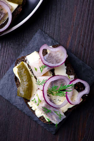 Sandwich with butter, herring on a black slate plateの写真素材