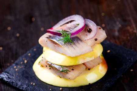 Appetizer canape with herring and applesの写真素材