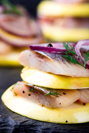 Appetizer canape with herring and apples