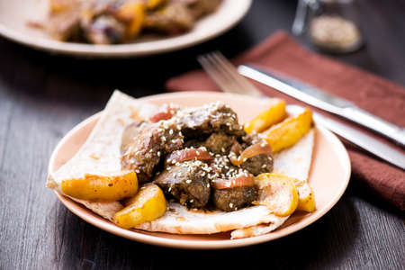 Stir-fried chicken kidney with apples and sesame seedsの写真素材