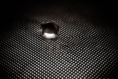 Metal ball on a latticeの写真素材