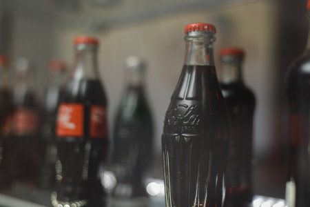 glass bottle of coca cola behind the showcase.のeditorial素材