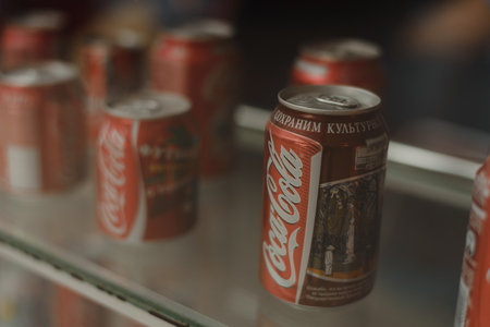Samara Russia- 04.30.2019: metal cans of coca cola behind the windowのeditorial素材
