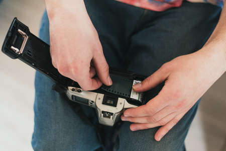 A man fills the camera film. put film in the camera.の写真素材