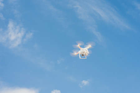 drone against the blue sky. quadcopter shoots the plot from above. Remote drone flies across the...