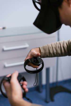 3D operation with glasses of virtual reality. The student of the medical university performs the operation in virtuality. Technologies of the futureの写真素材