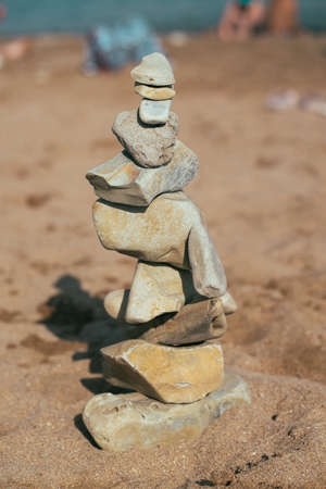 stones lie on the stones. feng shui on the beach. Creating a balance in the sand of stones.
