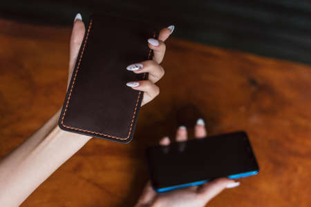 a leather case for the phone in the girl s hand.