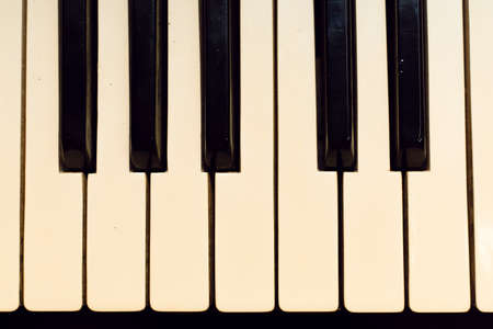 The keys of a classic ivory piano. View from above