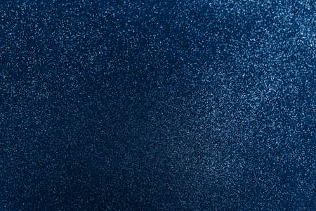 Glowing sparkles on blue color trendy background. Holiday bright brilliant beautiful background, template for blog or designers. Classic Flat lay. New Year 2020.の写真素材