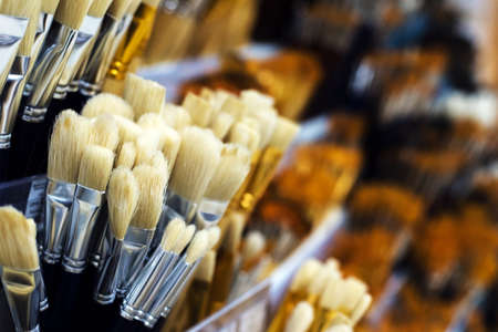 Group of artistic paintbrushes for artist. New paint brushes on shelf display in stationery shop....