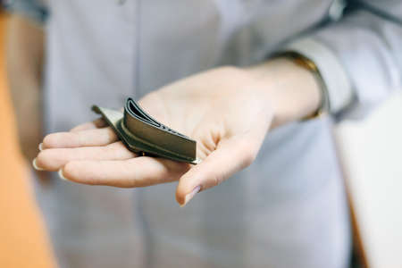 Female laboratory assistant in a white coat holds a metal part. Creating an airplane blade.の写真素材