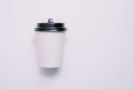 Coffee in a cardboard cup on a white background isolation. Top view, flat lay.の写真素材