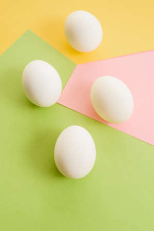 White eggs on a colorful background. minimal fashion concept , flat lay , top view.