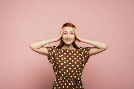 Dynamic image of caucasian female model on pink studio background. Winning success happy woman...