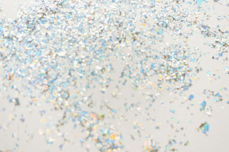 Pink pastel festive background with confetti and sparkles. Flat lay style.