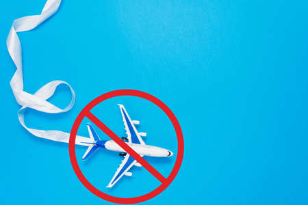 Ban on flights of civil aircraft. Prohibition sign. Cancellation of flights due to coronavirus. The sign of the ban and a miniature toy aircraft.の写真素材