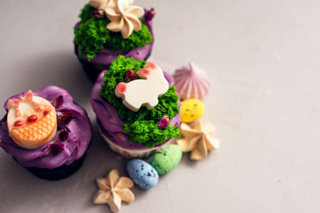 Easter cupcakes with different decorations made of chocolate and cream on a gray background.の写真素材