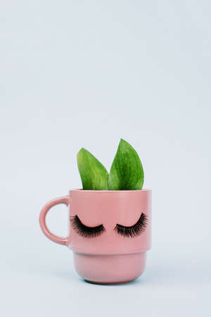 The concept of female morning and natural coffee. Pink mug of morning coffee with ears like a rabbit...