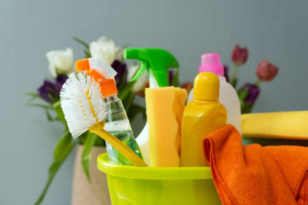 Detergents are in a bucket on the grey background. Cleaning in a house. Clean and wash house.の写真素材