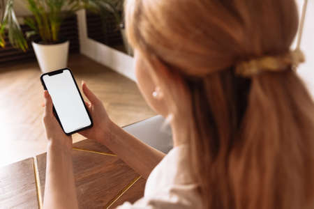 A young freelancer works from home using a telephone. Communication and work during self-isolation...