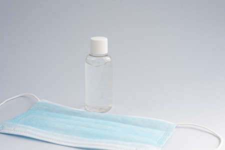 Antiseptic and protective mask for the respiratory tract on a blue background. Precautions for the...