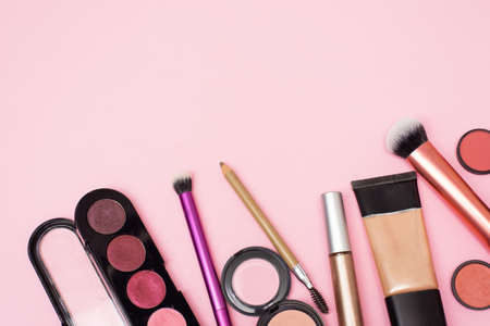 Place for text. Makeup products and decorative cosmetics on color background flat lay. Fashion and beauty blogger concept.の写真素材
