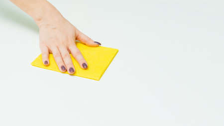 Housekeeping and household chores. Spring cleaning. hand with wet wipe cleaning table. Close up.の写真素材