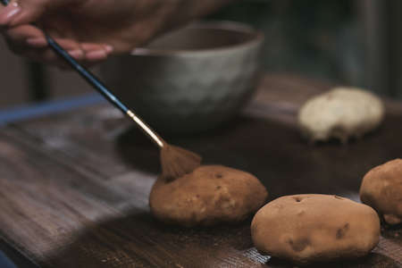 cooking potato cake on a dark wooden background. cooking rum ball.の写真素材