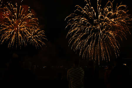 People watch the fireworks. Fourth of July Fireworks. Fireworks light up the sky with dazzling...