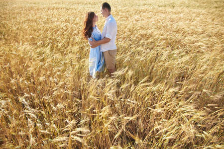 Awesome happy couple have fun in a field sunset background. Lifestyle and travel concept.の写真素材