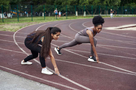 Who is faster. Leadership and primacy concept. Two young women race in the open stadium.の写真素材