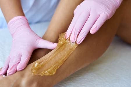 Cosmetologist is applying epilation paste. The hair removal procedure.の写真素材