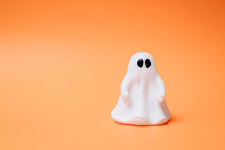 Artificial beautiful ghost on an orange background. Copy space for text. Festive concept.の写真素材