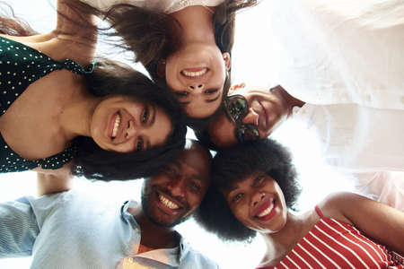Group Of Happy International People Standing In Circle And Looking Down At Camera. Diversity, race, ethnicity and people concept.の写真素材