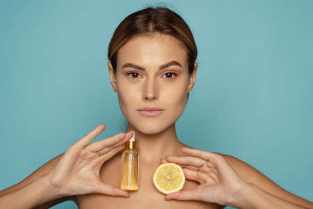 Model Using Natural Cosmetic Product For Hydrated, Glowing And Healthy Facial Derma. Essential Oil For Anti-Aging Therapy. Serum with vitamin c.の写真素材