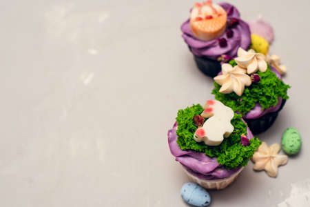 Easter food concept. Idea for kids. Decorating Easter bunny cupcakes with meringues.の写真素材
