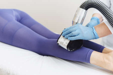 Young woman doing LPG leg procedure. Advertising. Lymphatic drainage massage LPG apparatus process.の写真素材