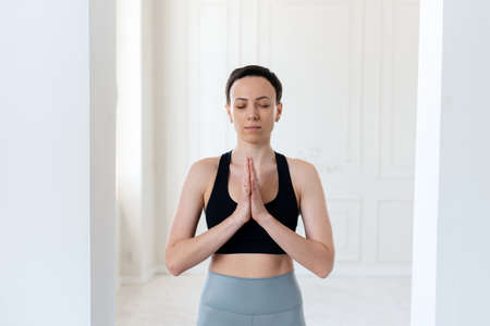 Practicing yoga. Young woman practices yoga and praysの写真素材