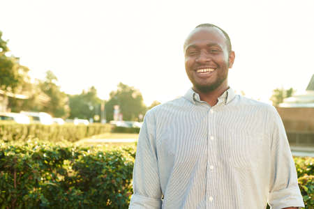 Happy smiling man outdoors. Outdoor portrait of smiling young african man on the parkの写真素材