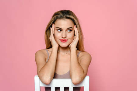 Casual beauty concept of pretty young woman on pink backgroundの写真素材