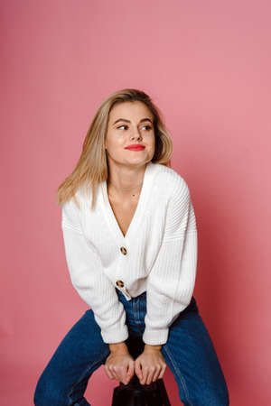 Casual beauty concept of pretty young woman on pink backgroundの写真素材