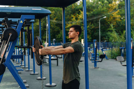 Handsome young european man doing life strength fitness workout with weightlifting barbell. Healthy lifestyle sports conceptの写真素材