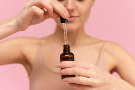 Model Using Natural Cosmetic Product For Hydrated, Glowing And Healthy Facial Derma. Essential Oil For Anti-Aging Therapyの写真素材